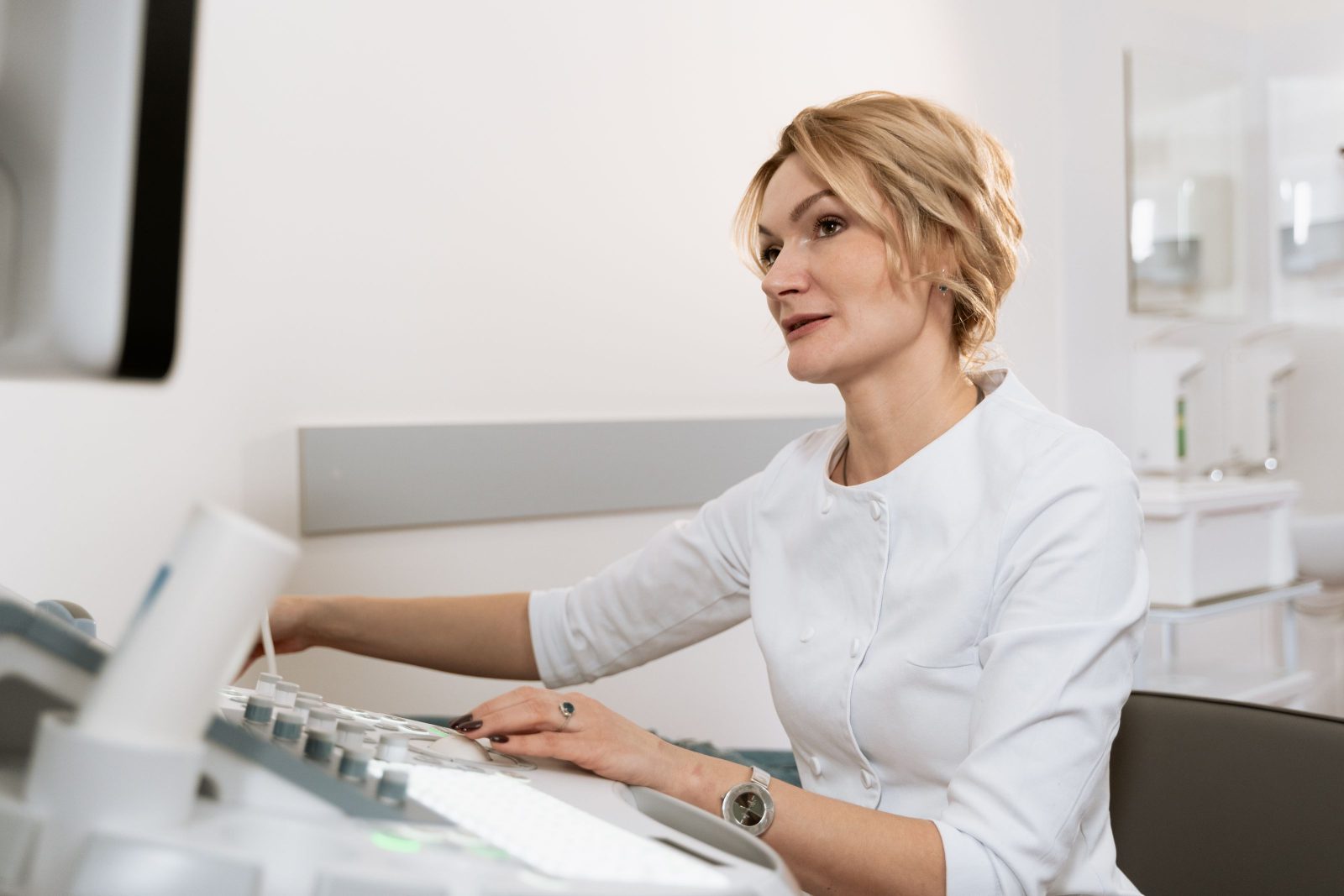 A female physician reviewing results at a desk in a bright clinic room